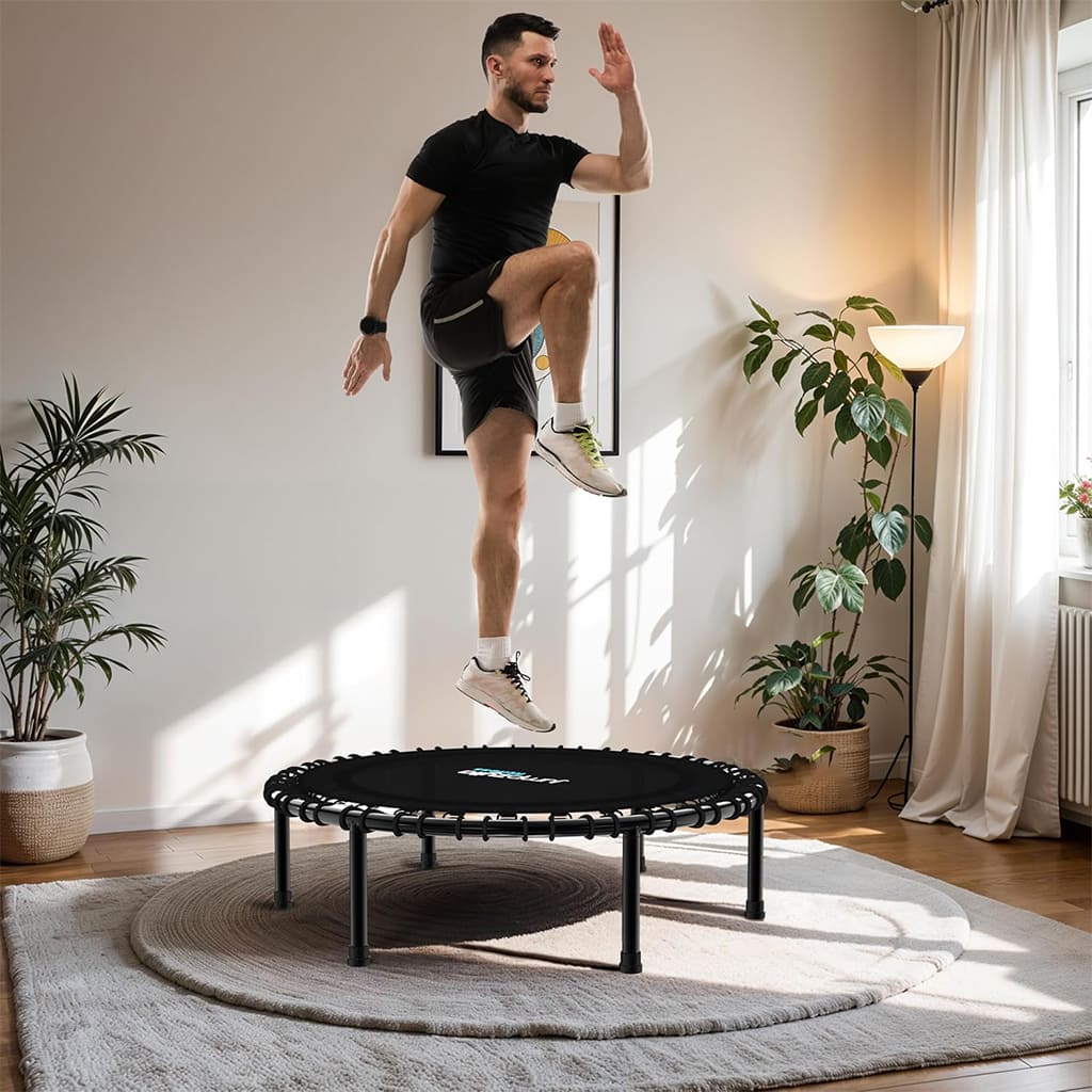 Ahoj Krása JumpGlow in use with a man jumping on a fitness trampoline in a stylish home setting.