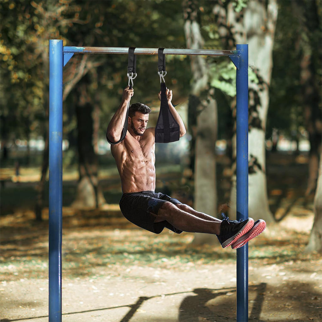 Ahoj Krása CoreGlide used by a fit man exercising core muscles outdoors on a pull-up bar.
